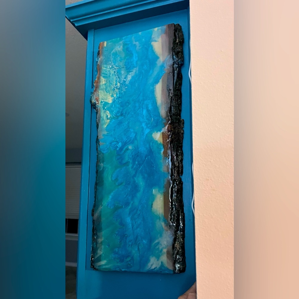 Handmade epoxy art on a cedar wood plank.